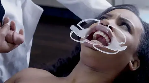 Medic nails face of astonished patient in the clinic